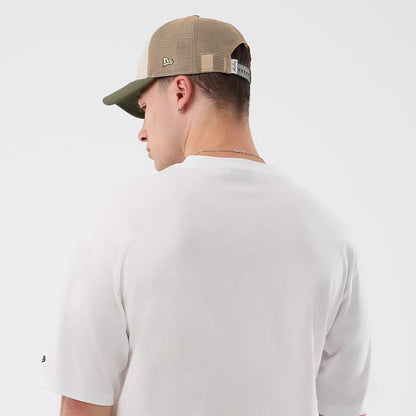 The model is wearing this New Era Beach Graphic Oversized T-Shirt in white. 8