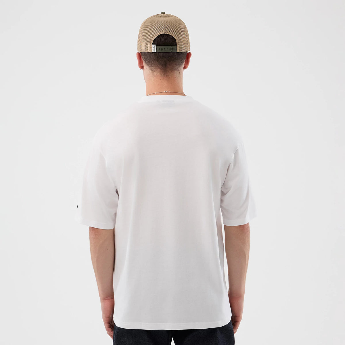 The model is wearing this New Era Beach Graphic Oversized T-Shirt in white. 2