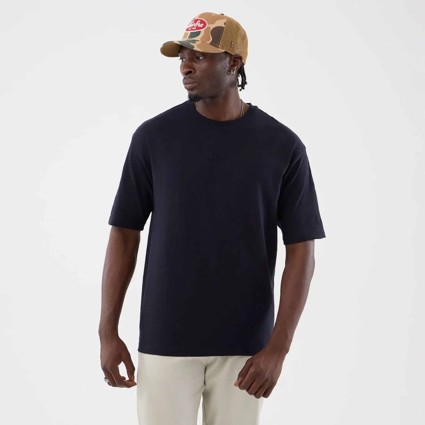 The model is wearing this New Era Slub Oversized T-Shirt in navy. 3