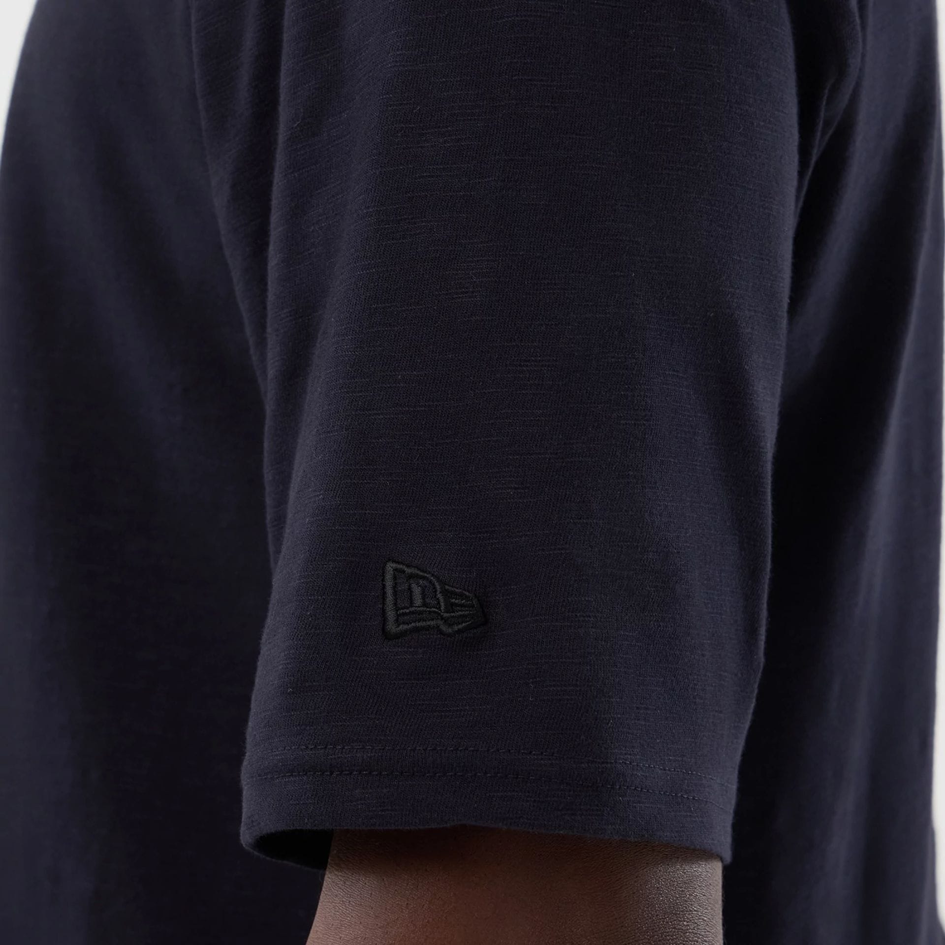 The model is wearing this New Era Slub Oversized T-Shirt in navy. 5