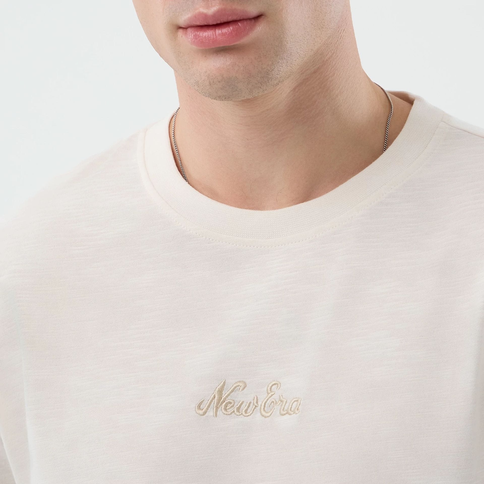 The model is wearing this New Era Slub Oversized T-Shirt in open white. 5