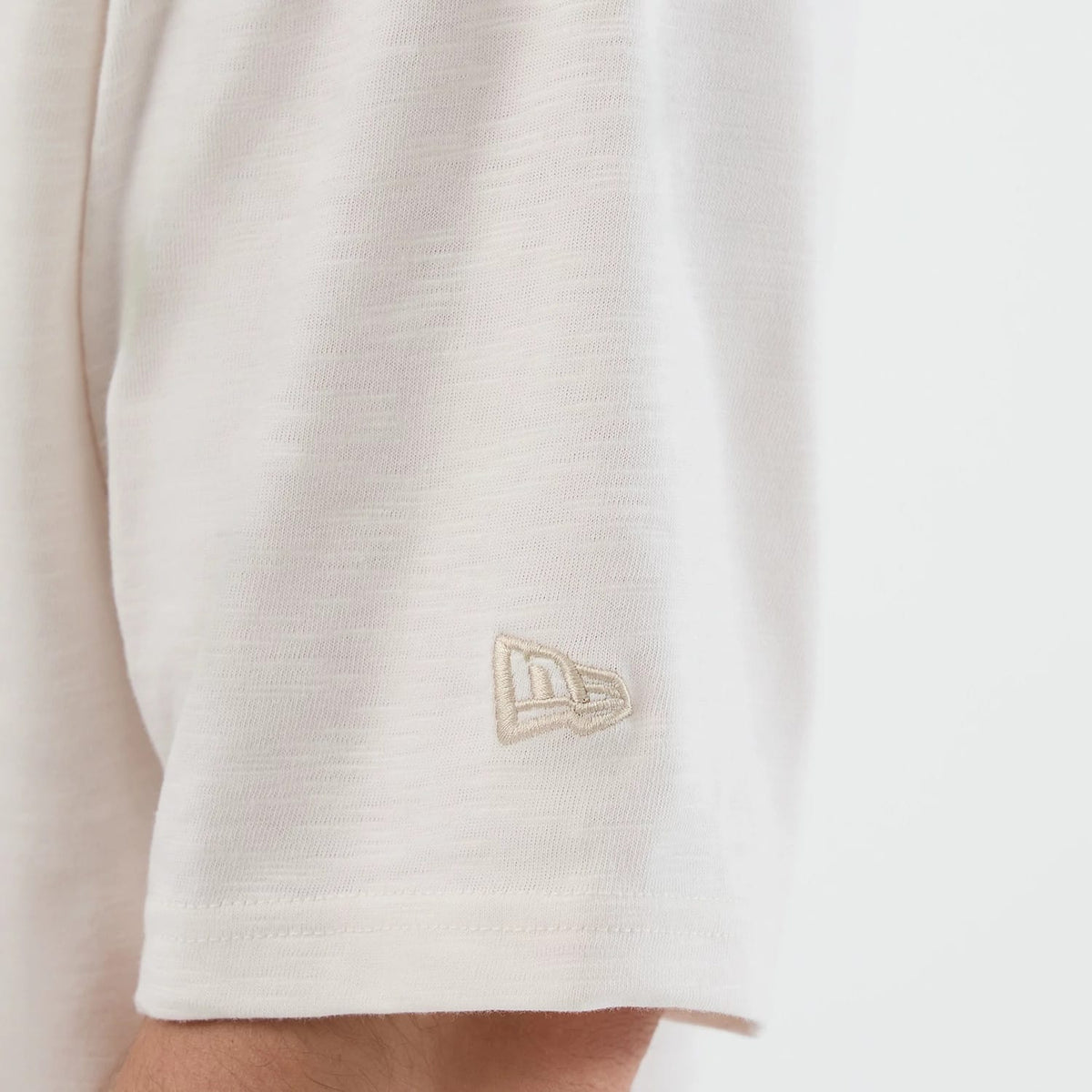 The model is wearing this New Era Slub Oversized T-Shirt in open white. 6