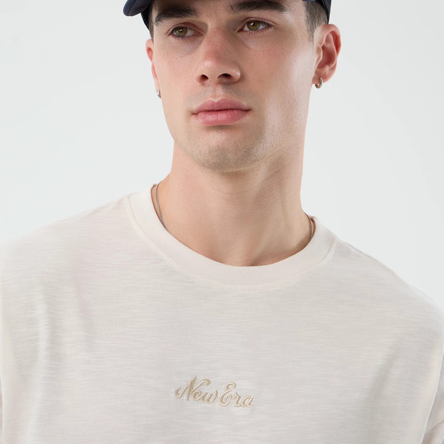 The model is wearing this New Era Slub Oversized T-Shirt in open white. 3