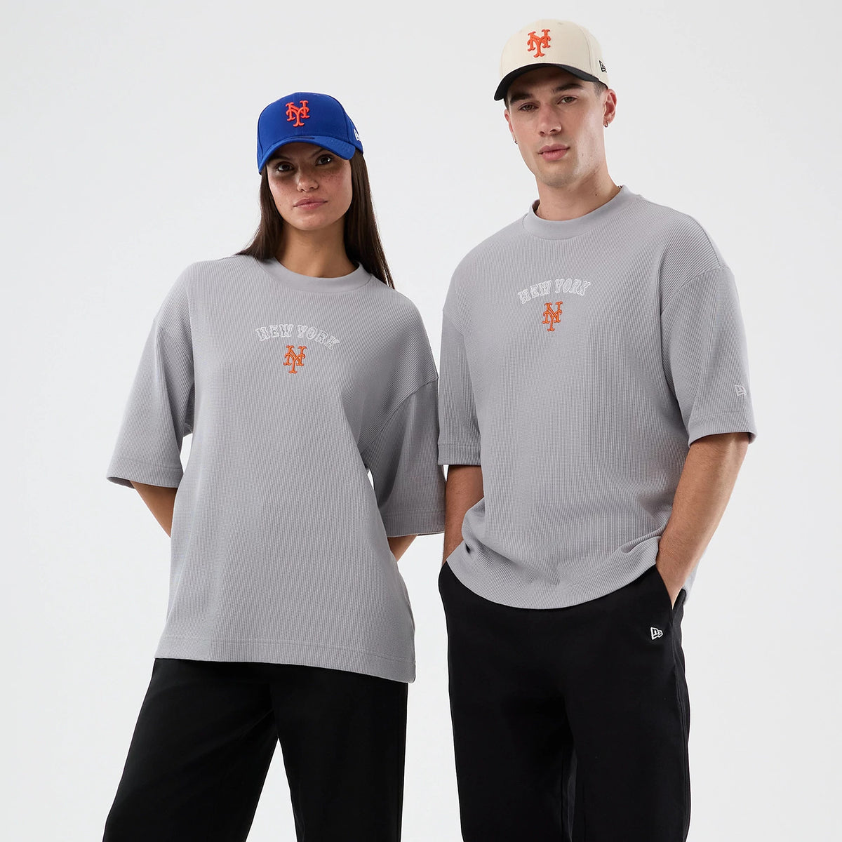 New Era New York Mets MLB Waffle Grey T-Shirt, on-model front view featuring a grey oversized fit with New York embroidered across the chest, a Mets logo below in orange, and another small New Era logo embroidered on the left sleeve.