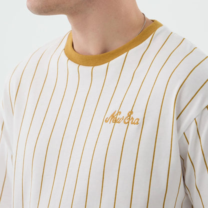 The model is wearing this New Era Pinstripe Oversized T-Shirt in white. 4