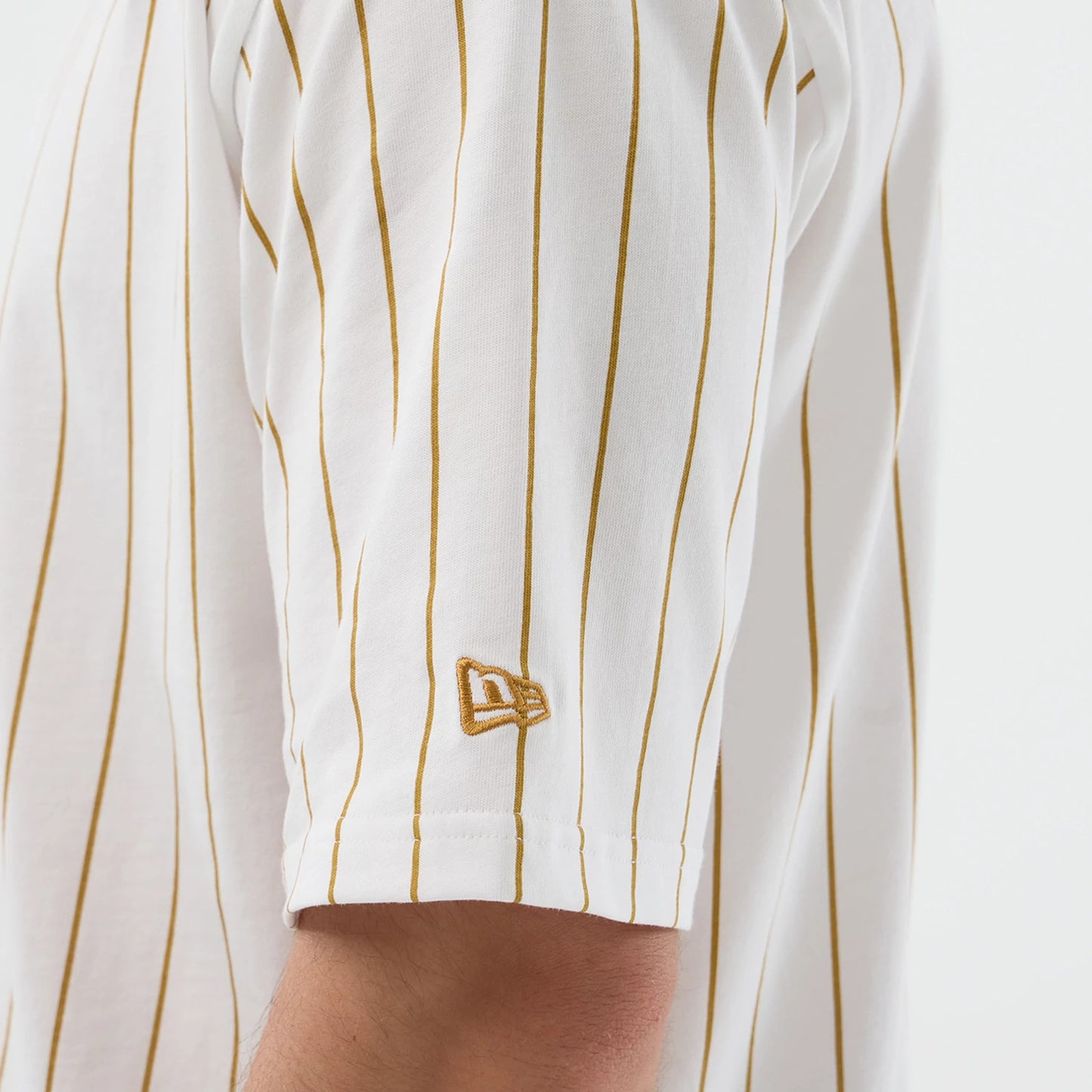 The model is wearing this New Era Pinstripe Oversized T-Shirt in white. 5