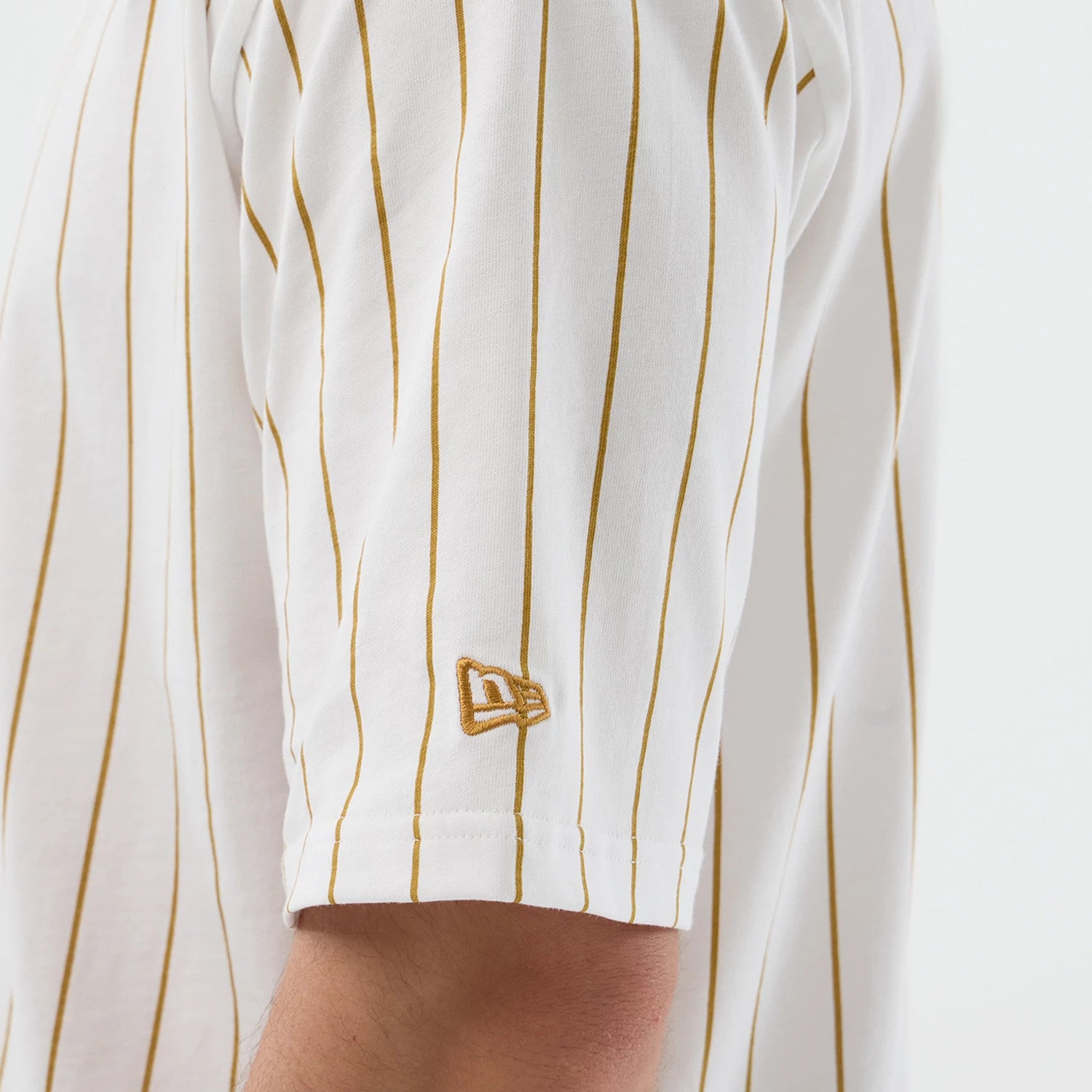 The model is wearing this New Era Pinstripe Oversized T-Shirt in white. 5