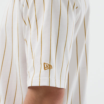 The model is wearing this New Era Pinstripe Oversized T-Shirt in white. 5