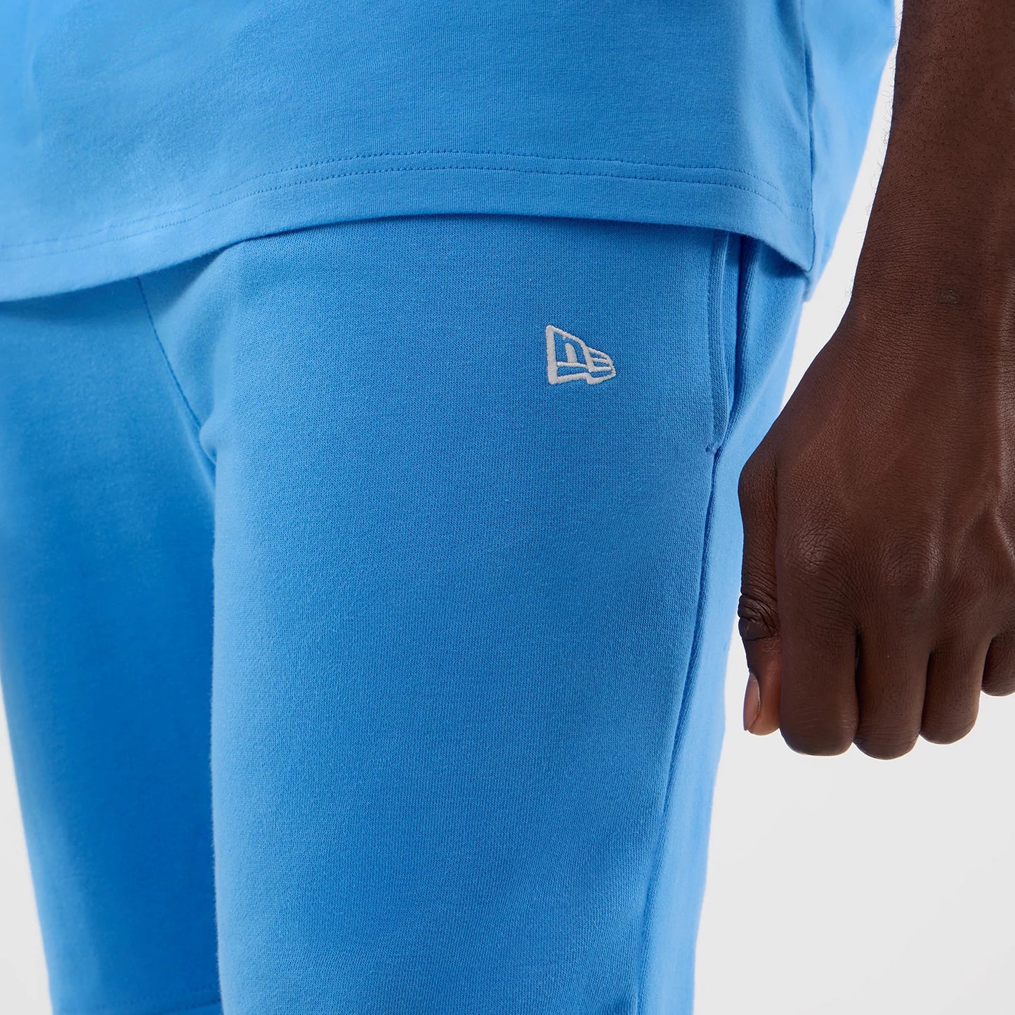 The model is wearing this MLB League Essential New York Yankees Shorts in pastel blue. 6
