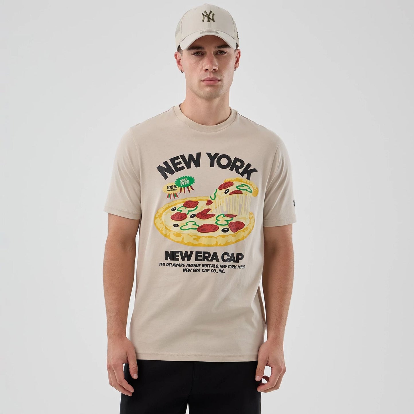 The model is wearing this New Era Pizza Graphic T-Shirt in light beige. 3