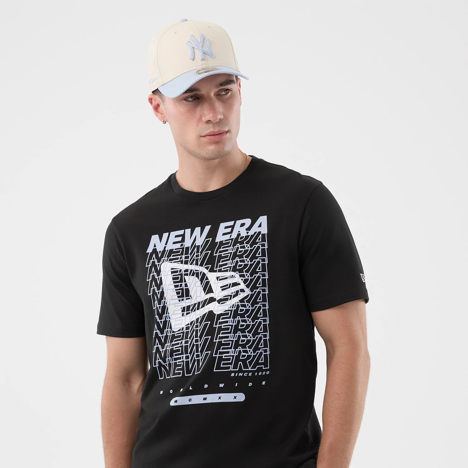 The model is wearing this New Era Logo Graphic T-Shirt in black. 3