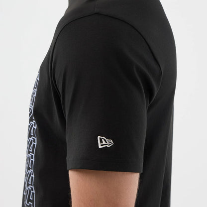 The model is wearing this New Era Logo Graphic T-Shirt in black. 5