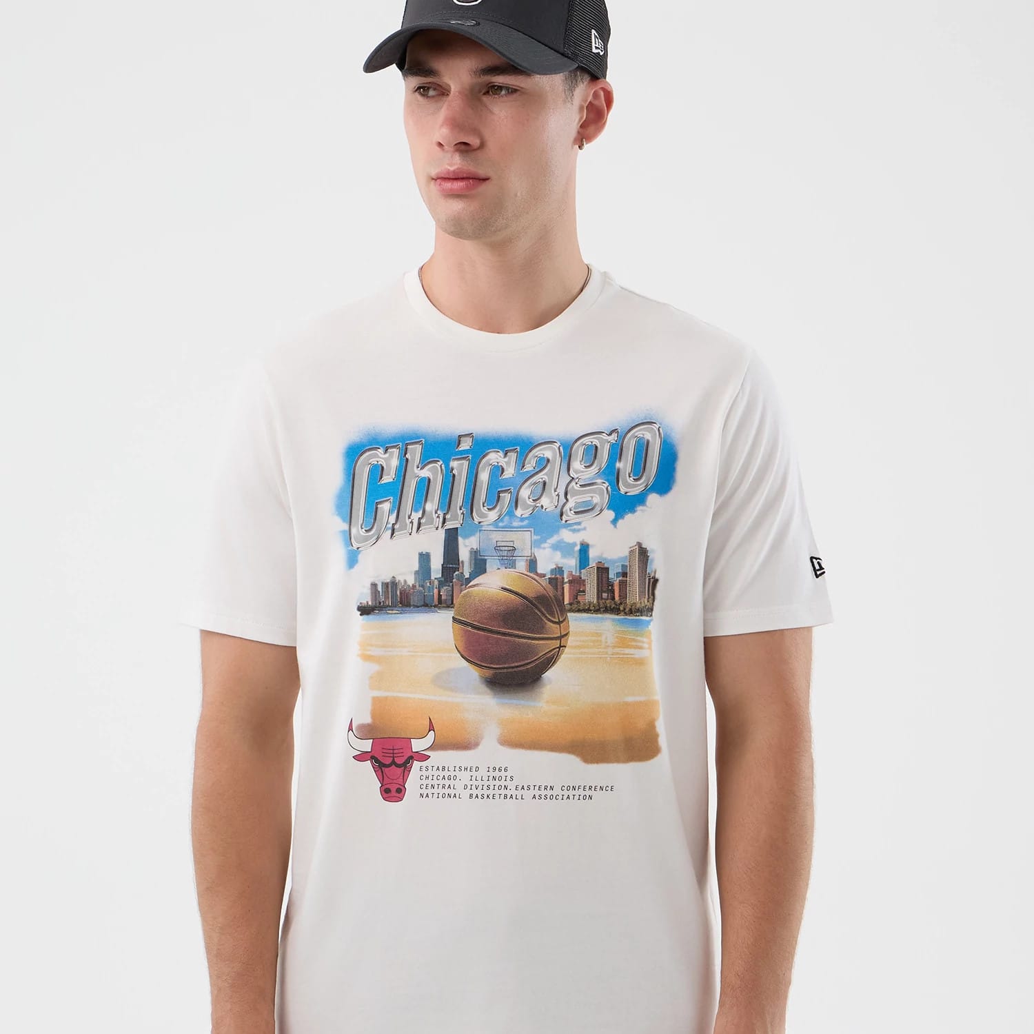 The model is wearing this NBA Beach Graphic Chicago Bulls T-Shirt in white. 3