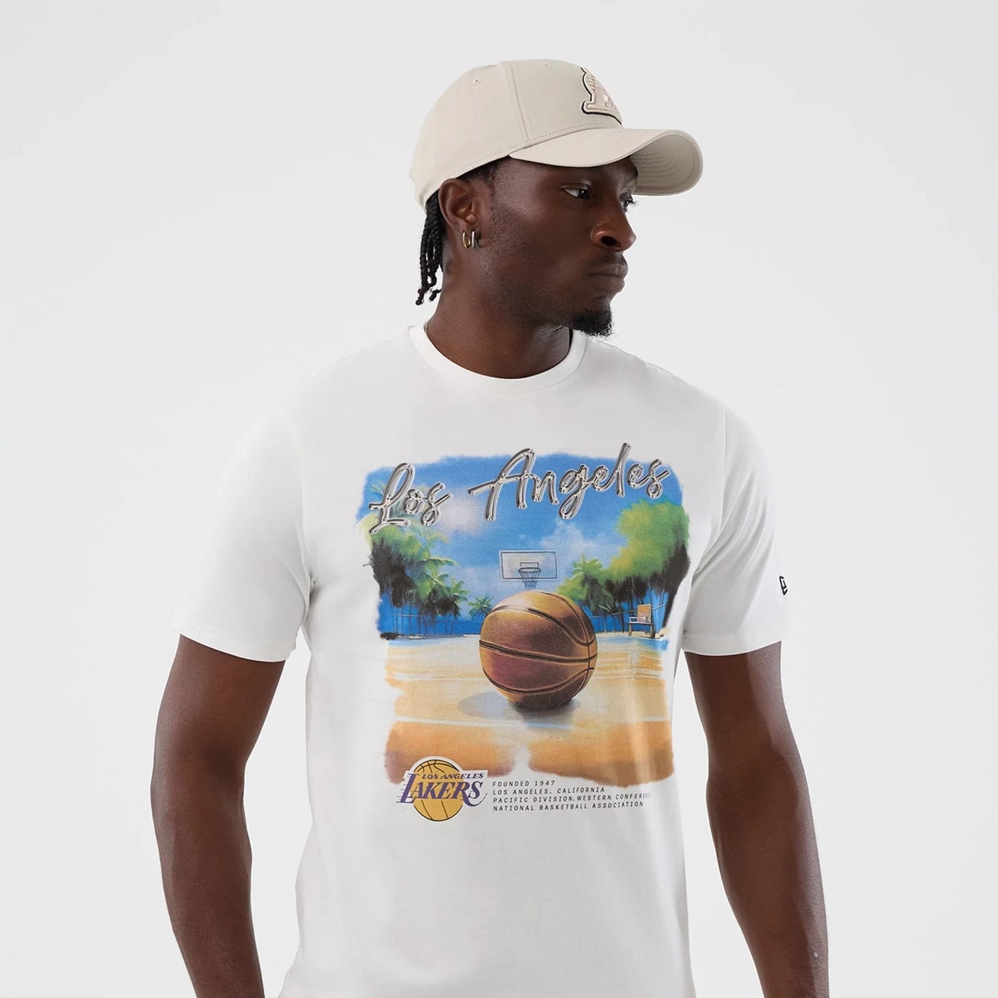 The model is wearing this NBA Beach Graphic LA Lakers T-Shirt in white. 3