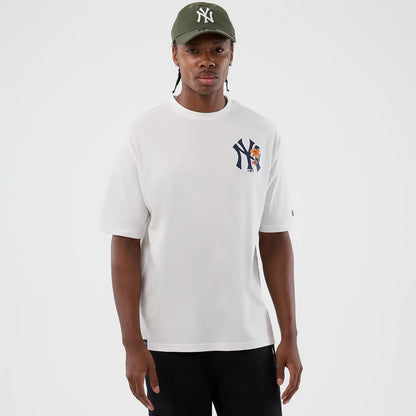 New Era New York Yankees MLB Floral White Oversized T-Shirt, front view on a model showcasing the white oversized fit with a colourful floral graphic and navy Yankees logo on the left chest, and a small embroidered New Era flag on the sleeve.