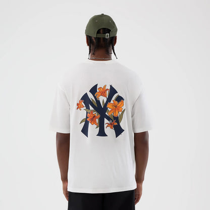 The model is wearing this MLB Floral New York Yankees Oversized T-Shirt in white. 2