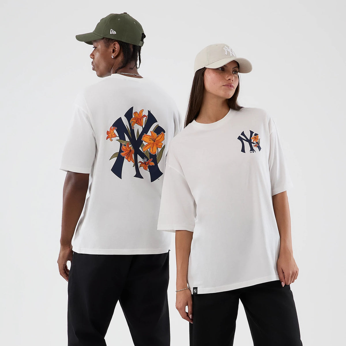 The model is wearing this MLB Floral New York Yankees Oversized T-Shirt in white. 1
