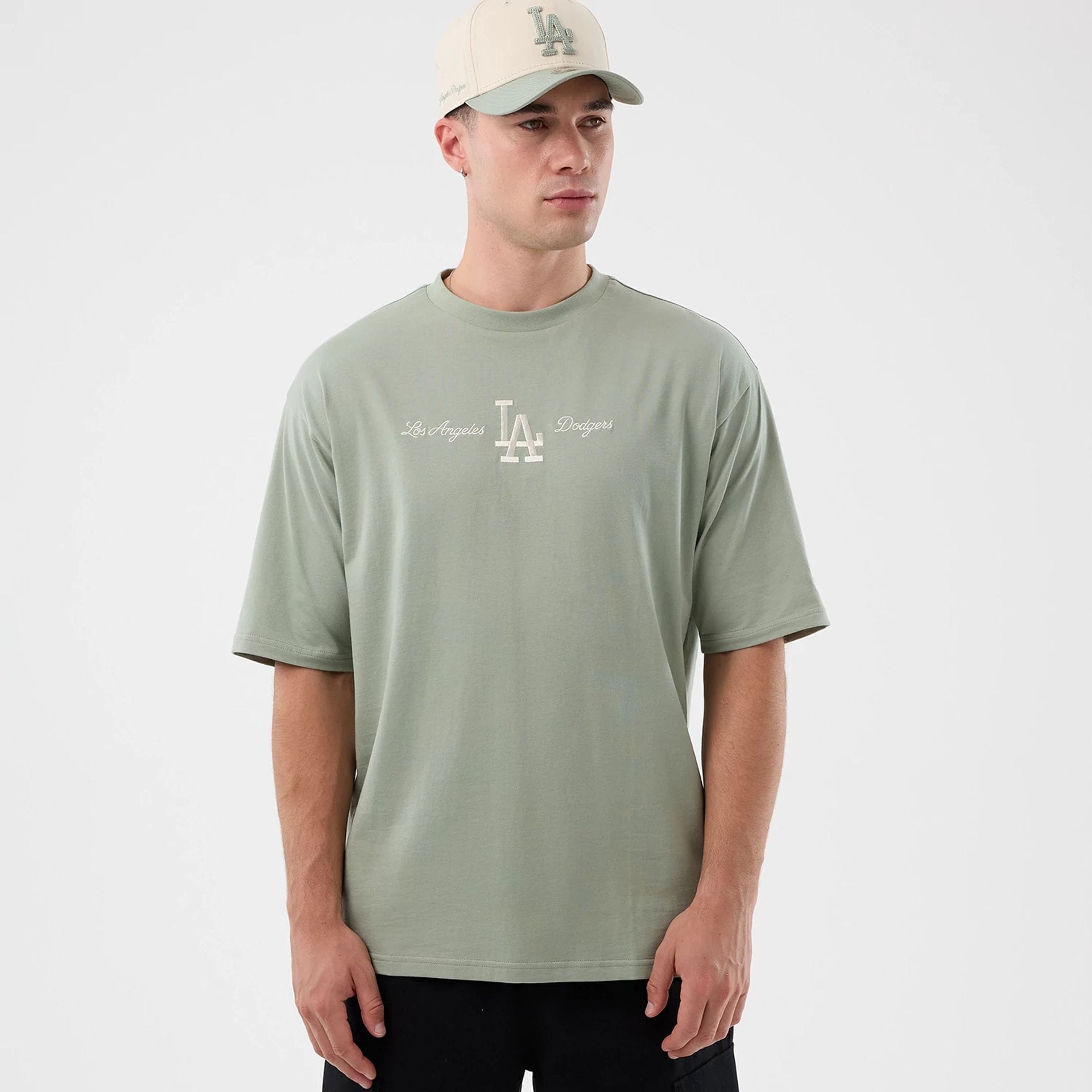 The model is wearing this MLB Script LA Dodgers Oversized T-Shirt in pastel green. 3