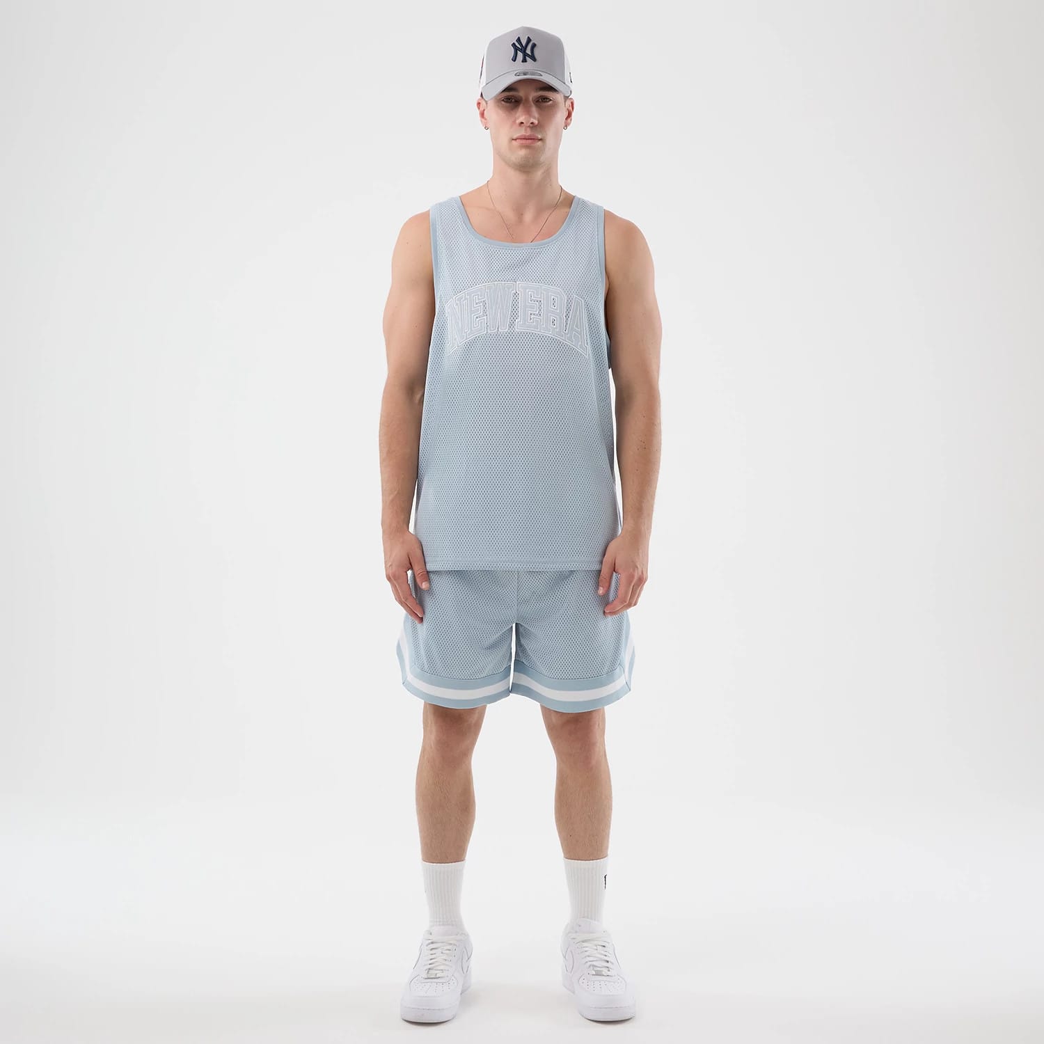 The model is wearing this New Era Mesh Oversized Tank Top in pastel blue. 8