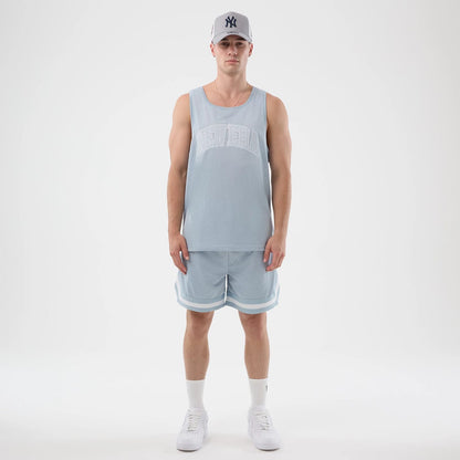 The model is wearing this New Era Mesh Oversized Tank Top in pastel blue. 8