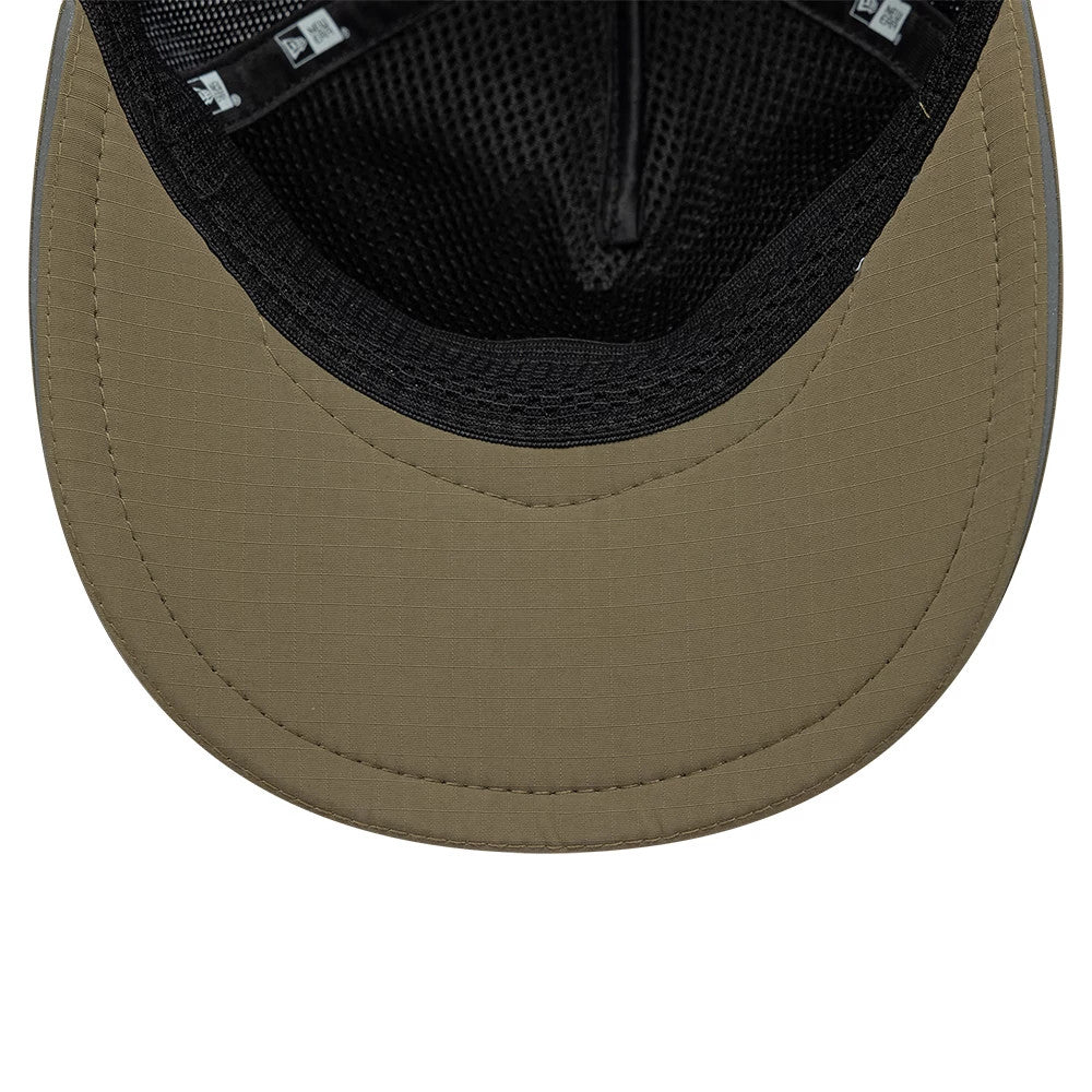 New Era Performance Green 9FORTY M-Crown A-Frame Trucker Adjustable Cap, inside view showing the olive green curved visor, black mesh sweatband and taping, with a grid pattern on the undervisor and a branded label on the interior.