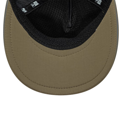 New Era Performance Green 9FORTY M-Crown A-Frame Trucker Adjustable Cap, inside view showing the olive green curved visor, black mesh sweatband and taping, with a grid pattern on the undervisor and a branded label on the interior.
