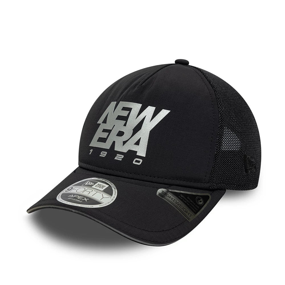 New Era Performance Black New Era 9FORTY M-Crown A-Frame Trucker Adjustable Cap, three-quarter view showing the large silver New Era 1920 logo in flat embroidery on the front panel, black curved visor with 9FORTY size sticker.