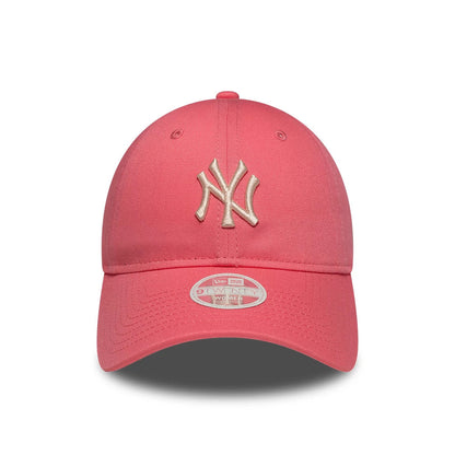 New York Yankees Womens MLB League Essential Pink New Era 9TWENTY Adjustable Cap, front view showing the raised gold embroidered NY logo on the structured pink crown, with a curved visor and a 9TWENTY size sticker on the visor.