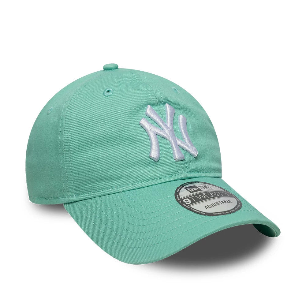 New York Yankees MLB League Essential Pastel Green New Era 9TWENTY Adjustable Cap, three-quarter view showing the raised white embroidered Yankees logo on the relaxed pastel green crown, matching curved visor and a 9TWENTY size sticker.