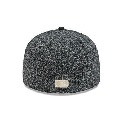 Chicago Cubs MLB Tweedy Cotton Black New Era 59FIFTY Fitted Cap, rear view showing an off-white embroidered MLB Batterman logo at the centre of the textured black tweed back panels, with a black top button and matching fabric eyelets.