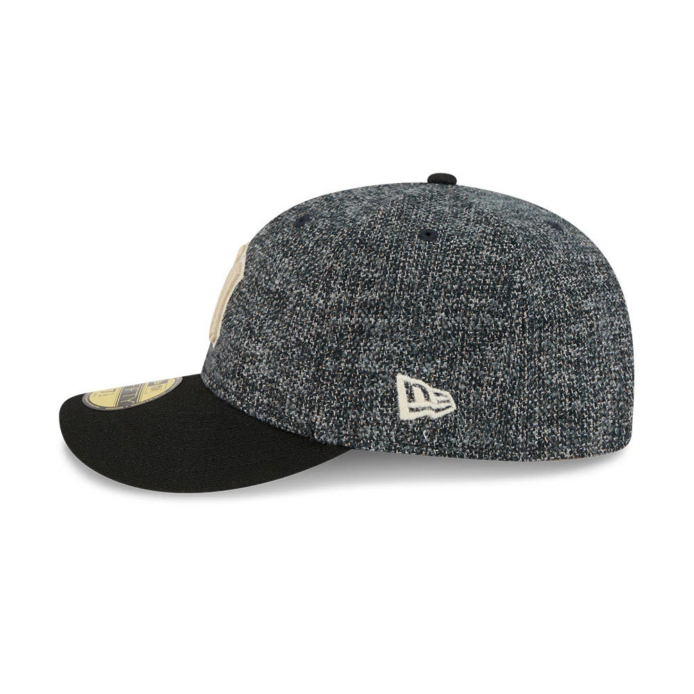 New York Yankees MLB Tweedy Cotton Black New Era 59FIFTY Fitted Cap, side view showing a black visor with a gold 59FIFTY size sticker, textured tweedy cotton fabric on the structured crown, and the white New Era flag logo on the left side.