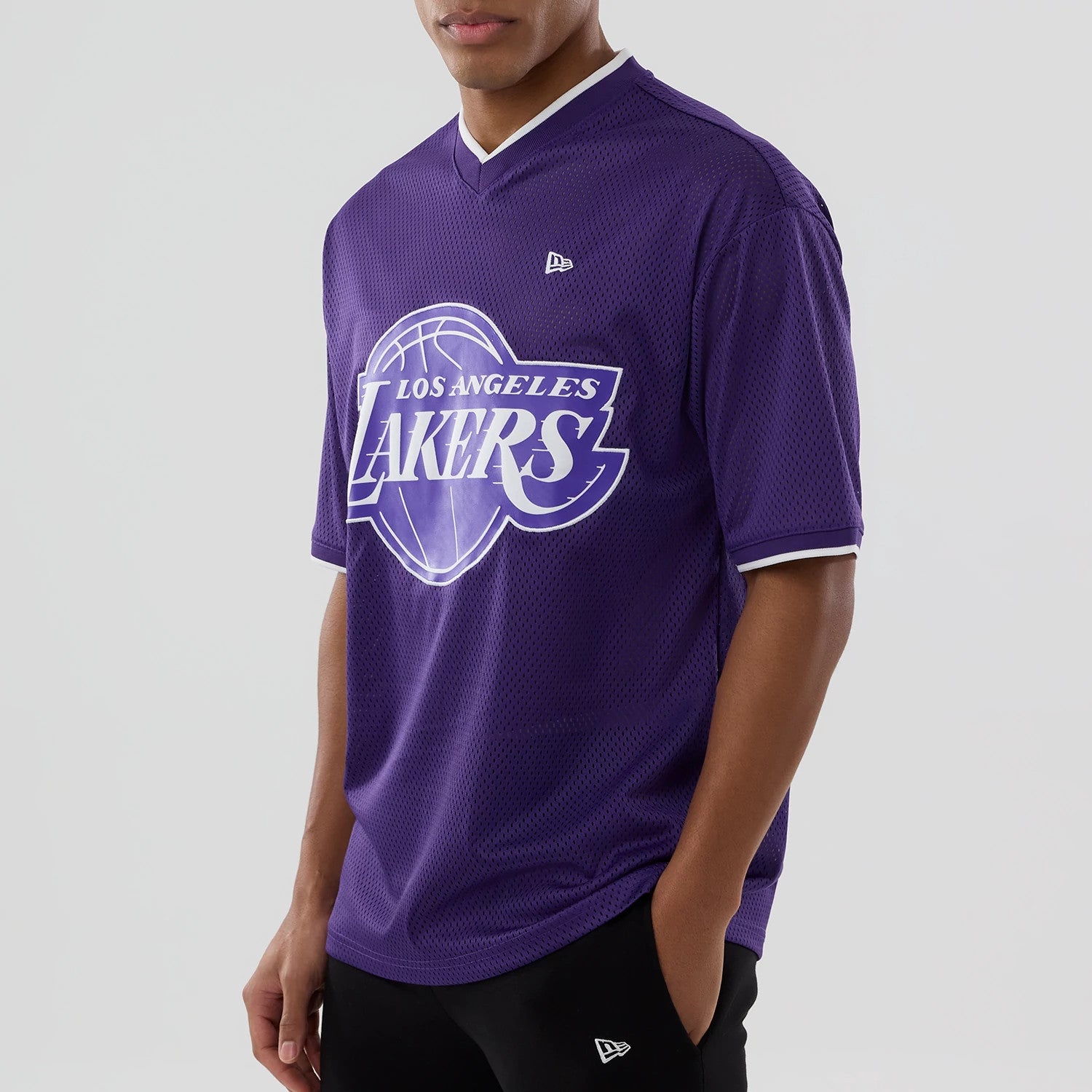 The model is wearing this NBA Mesh LA Lakers Oversized T-Shirt in purple. 4