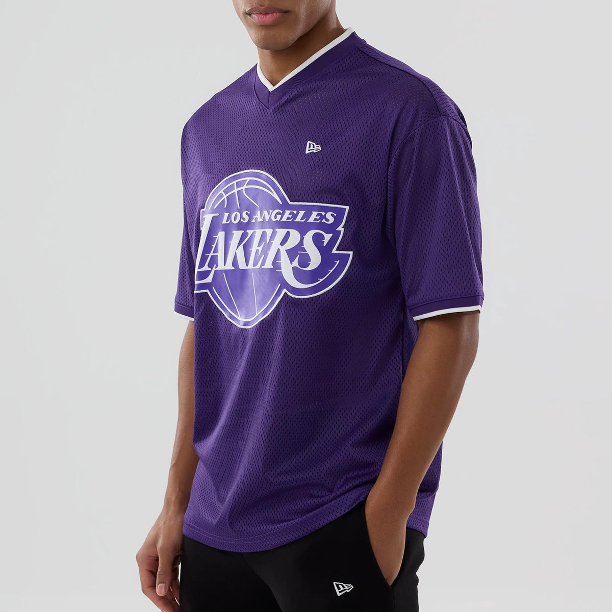 The model is wearing this NBA Mesh LA Lakers Oversized T-Shirt in purple. 4
