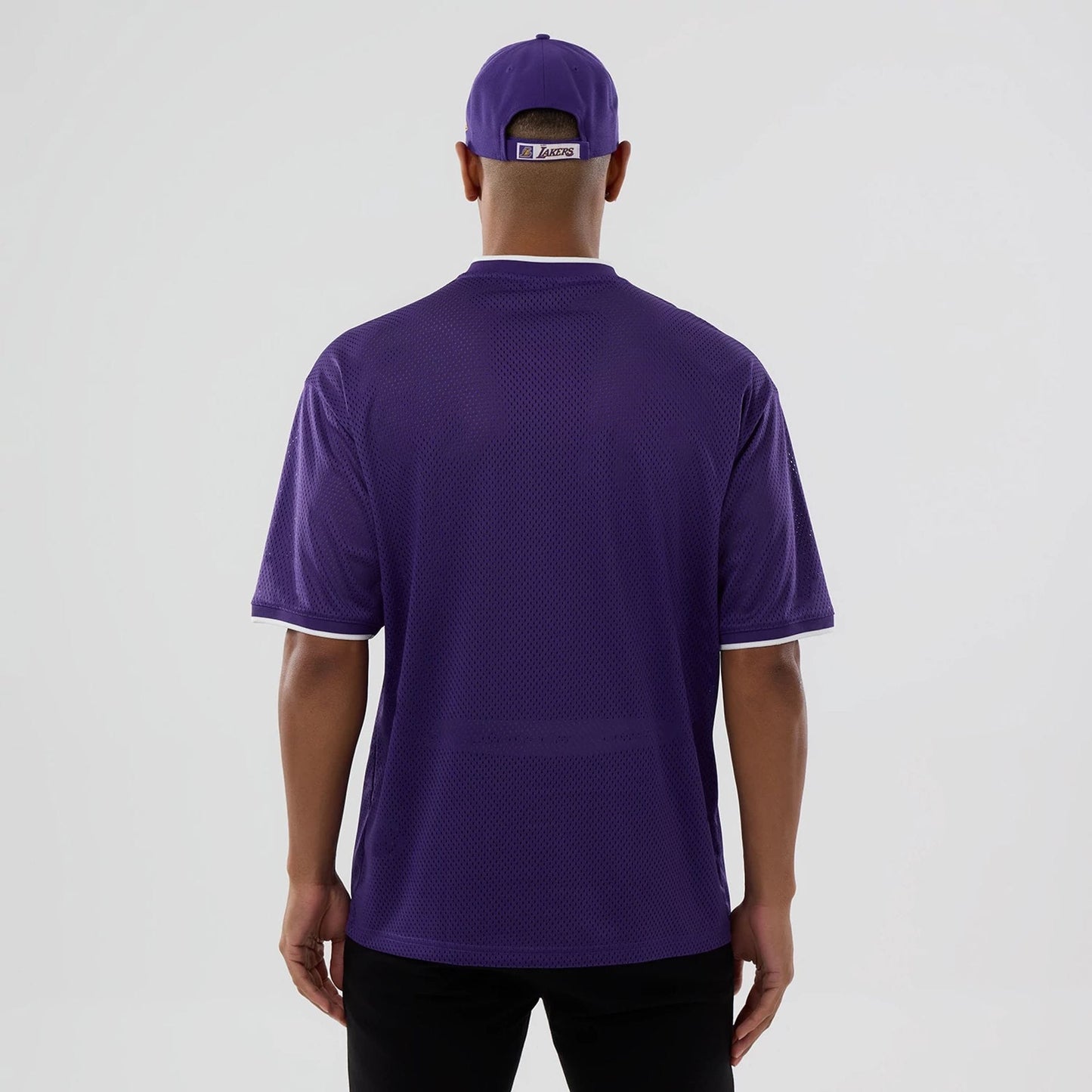 The model is wearing this NBA Mesh LA Lakers Oversized T-Shirt in purple. 2