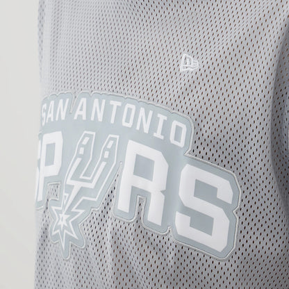 New Era San Antonio Spurs NBA Mesh Grey Oversized T-Shirt, front view showcasing a white printed San Antonio Spurs wordmark across the chest, grey mesh fabric texture, and a small embroidered New Era logo above the graphics on the left side.