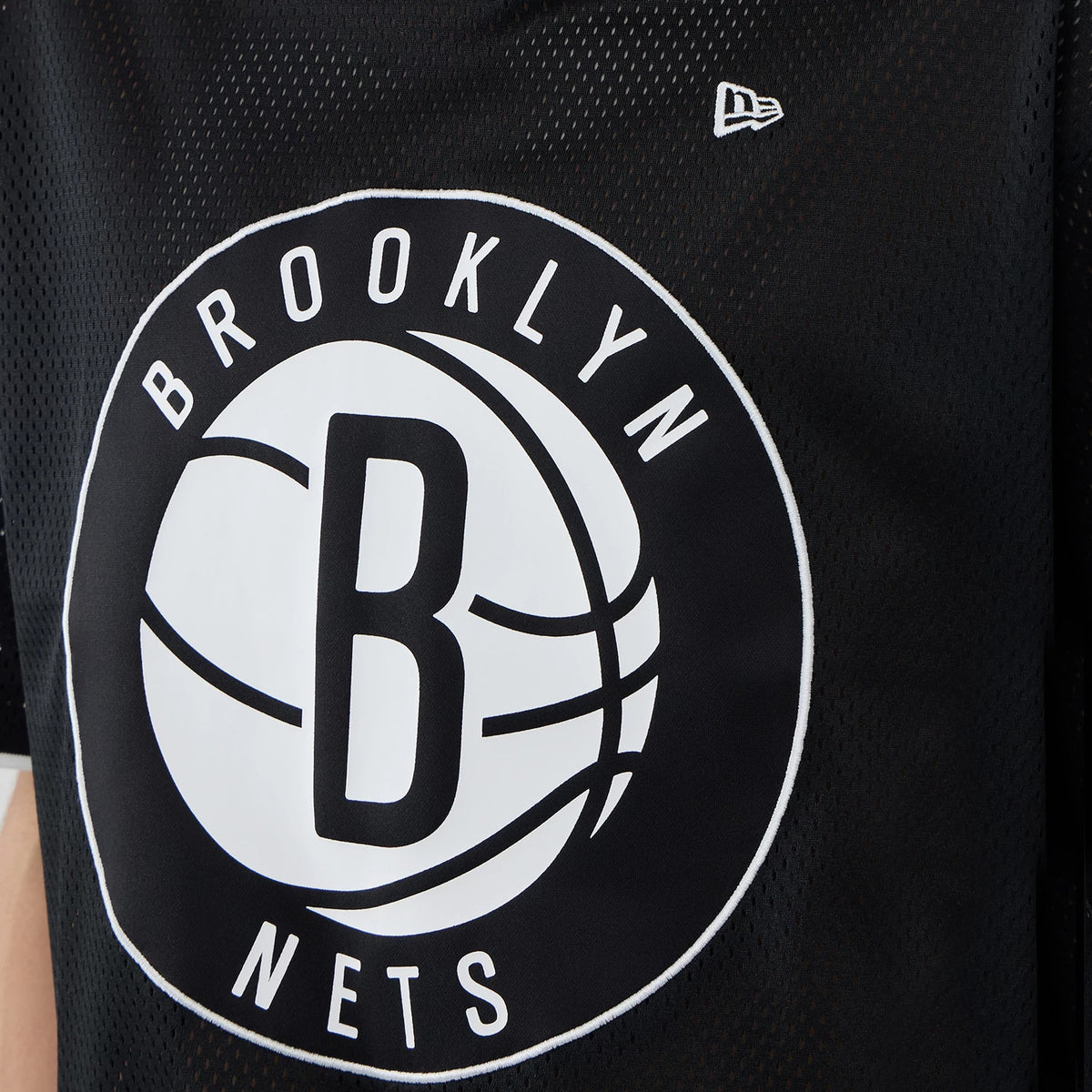 New Era Brooklyn Nets NBA Mesh Black Oversized T-Shirt, front view displaying a large white Brooklyn Nets basketball logo at the centre, detailed with black lettering and an embroidered New Era logo on the upper left chest area.