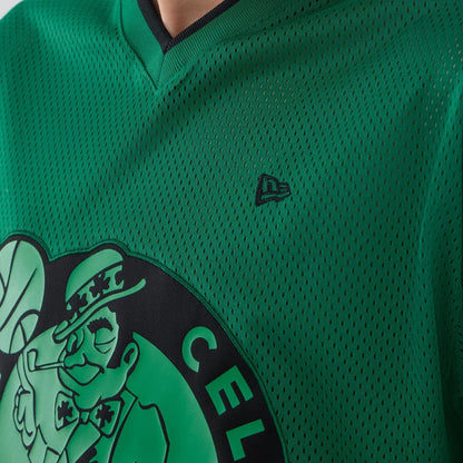 The model is wearing this NBA Mesh Boston Celtics Oversized T-Shirt in green. 5