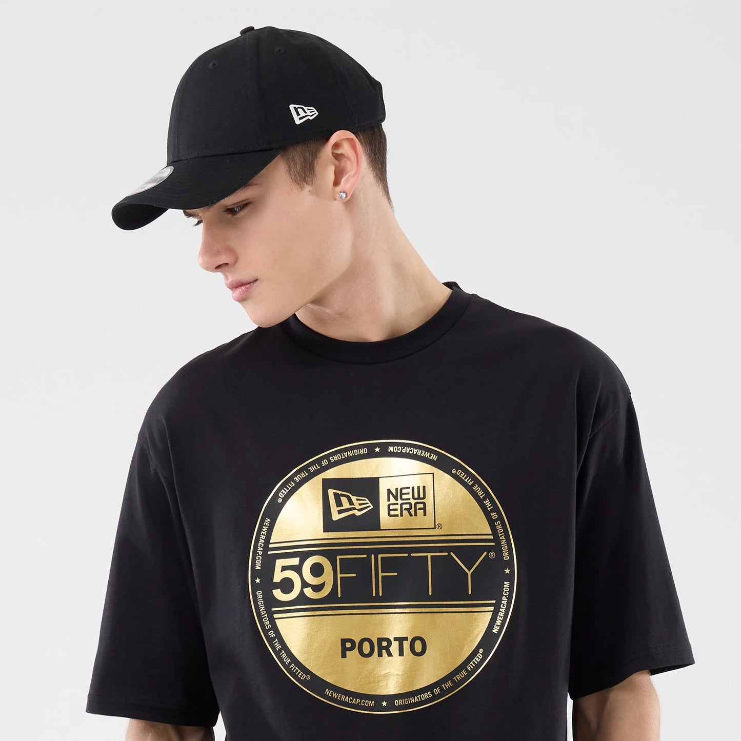 The model is wearing this New Era Sticker Porto Oversized T-Shirt in black. 6
