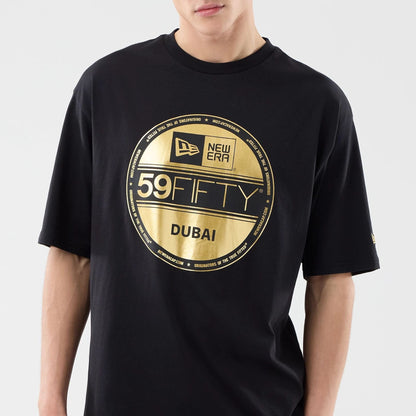 The model is wearing this New Era Sticker Dubai Oversized T-Shirt in black. 4
