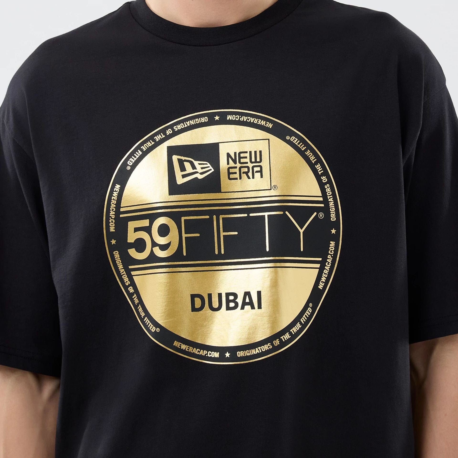 The model is wearing this New Era Sticker Dubai Oversized T-Shirt in black. 3