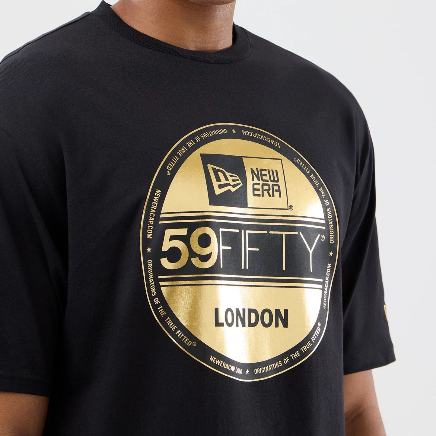 The model is wearing this New Era Sticker London Oversized T-Shirt in black. 5