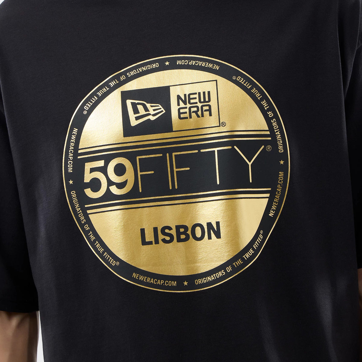 New Era Sticker Lisbon Black Oversized T-Shirt, back view showing a large gold printed circular logo centred on the black fabric, featuring New Era branding, 59FIFTY text, and Lisbon lettering in uppercase beneath.