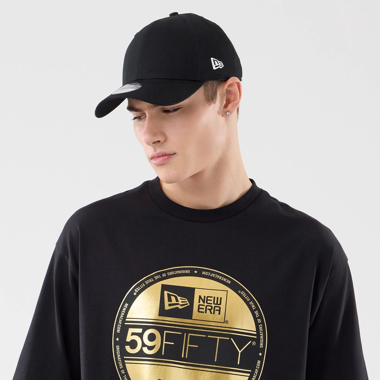 The model is wearing this New Era Sticker Lisbon Oversized T-Shirt in black. 6