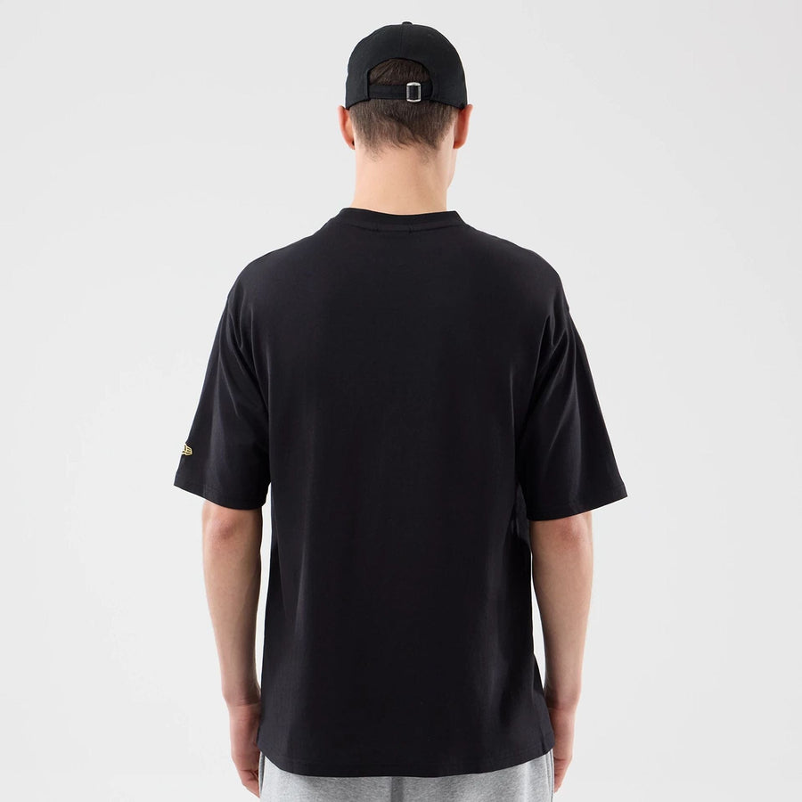 The model is wearing this New Era Sticker Lisbon Oversized T-Shirt in black. 2