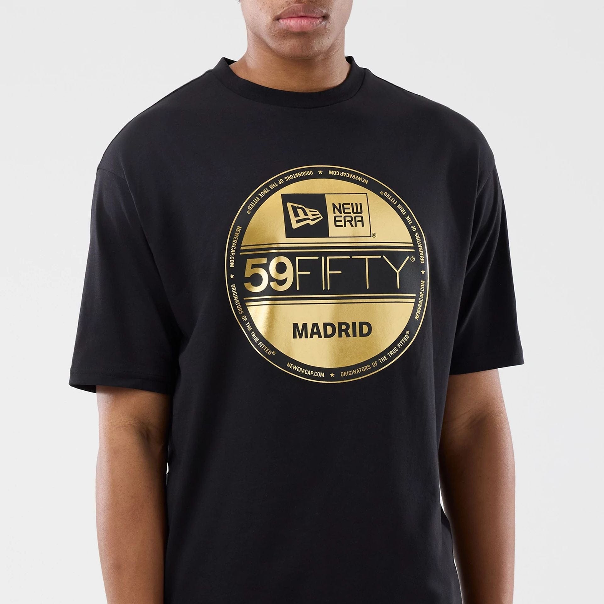 The model is wearing this New Era Sticker Madrid Oversized T-Shirt in black. 5