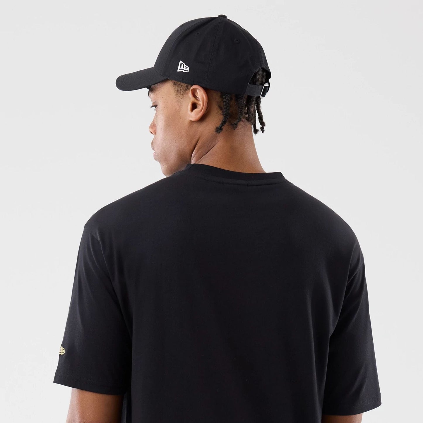 The model is wearing this New Era Sticker Madrid Oversized T-Shirt in black. 7