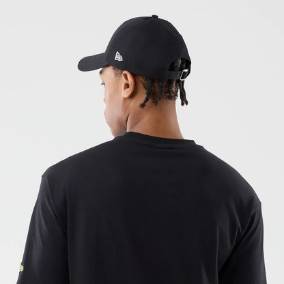 The model is wearing this New Era Sticker Copenhagen Oversized T-Shirt in black. 7