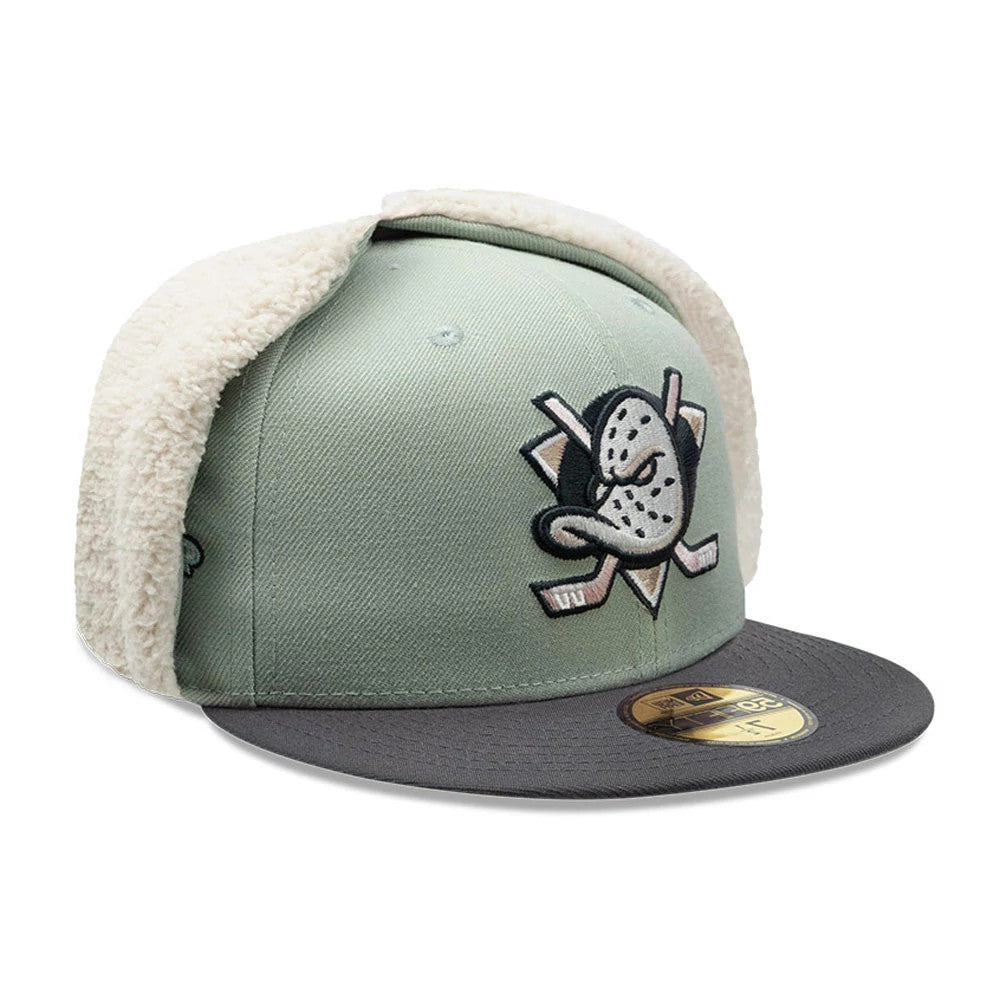 Anaheim Ducks NHL Patch Pastel Green New Era 59FIFTY Fitted Cap, three-quarter view showing the embroidered Ducks logo on the front panel, grey flat visor with gold 59FIFTY size sticker, and cream-coloured dogear flaps folded up.