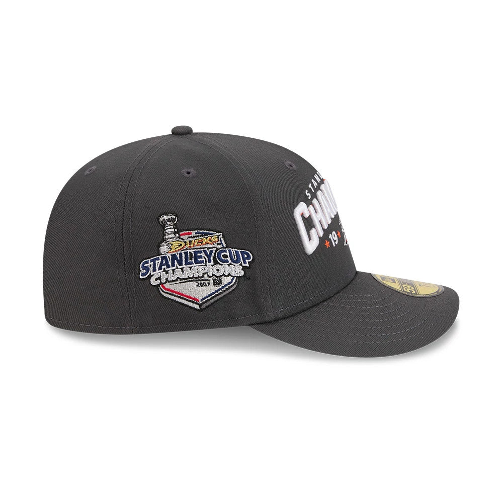 Anaheim Ducks NHL Stanley Cup Champions Dark Grey New Era 59FIFTY Fitted Cap, side view with the embroidered Stanley Cup Champions 2007 patch on the left panel, a flat dark grey visor, and the gold 59FIFTY size sticker on the visor.