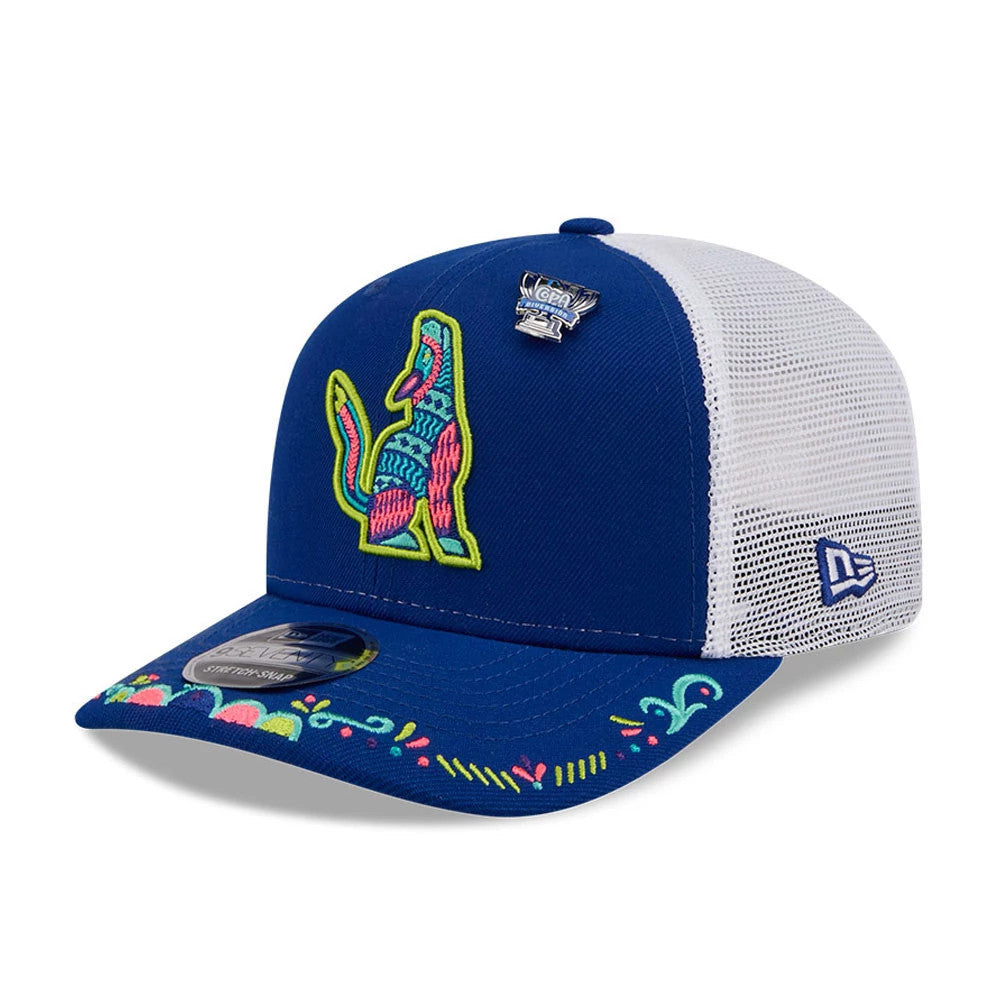 Hillsboro Hops MiLB La Copa 2026 Blue New Era 9SEVENTY Stretch Snap Adjustable Cap, three-quarter view showing a colourful embroidered logo of a wolf on the front panel, a floral pattern on the blue visor, and a white mesh rear panel.